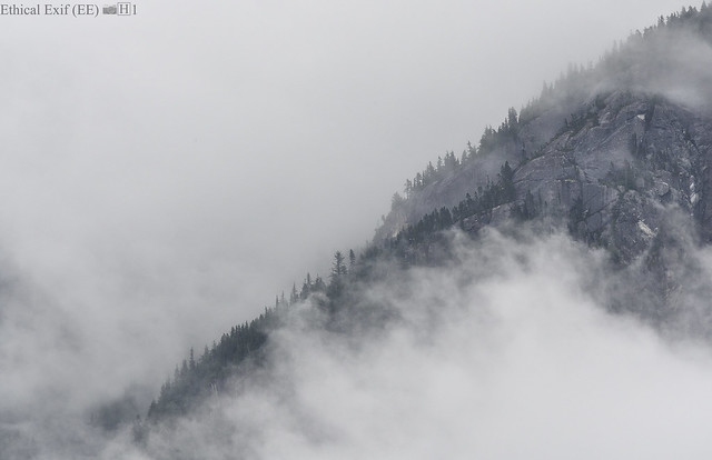 Clouds roiling over the forested mountains