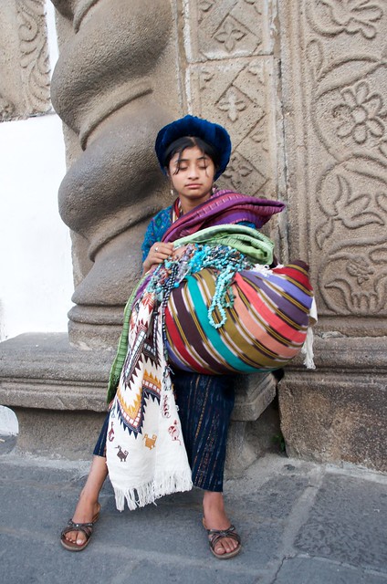 girl in hat selling blankets