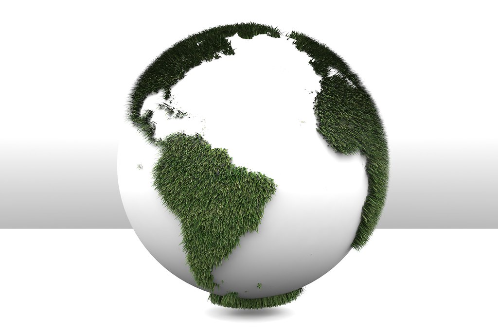 3D Green Planet Earth. Image shows a white sphere covered in  green grass representing the continents.