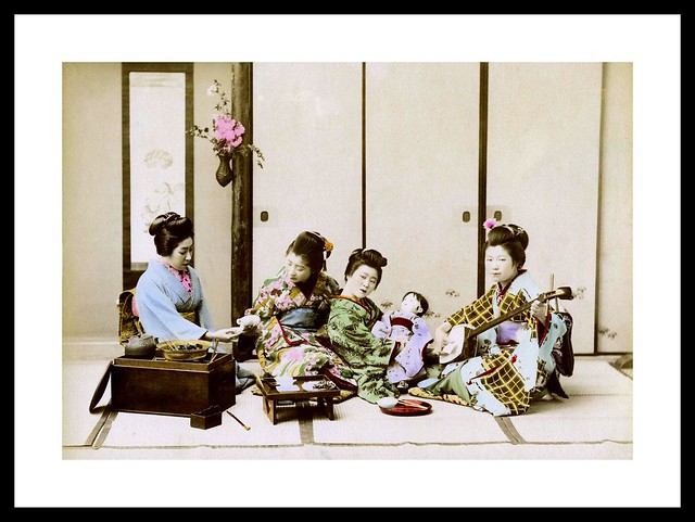 GEISHA AND MAIKO RELAX DURING A MEAL in OLD JAPAN