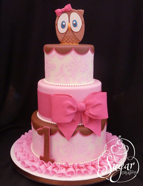 pink owl first birthday cake