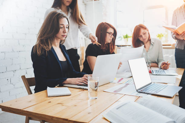 Group of coworkers work together in loft coworking studio. Teamworking - Credit to https://www.lyncconf.com/