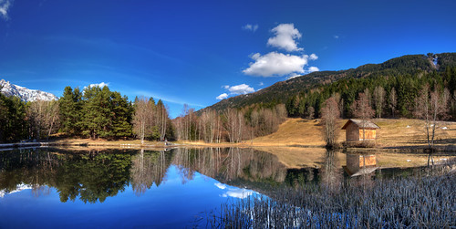 "Believe you can and you're halfway there" by traumlichtfabrik, blue trees sky panorama sun lake snow mountains alps reflection tree water clouds landscape geotagge