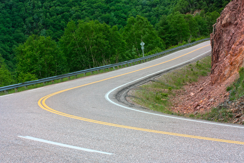 Winding road through green wooded hills