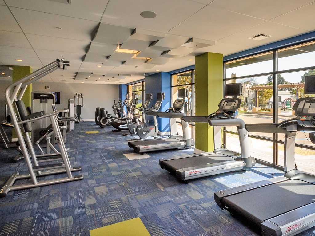 Fitness Center: Foster City Apartments - Spacious Fitness Center Featuring Varios Cardio Equipment