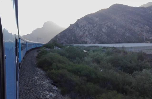 Premier Classe train to Cape Town passing through narrow valley between Hex River Valley & De Wet vineyards