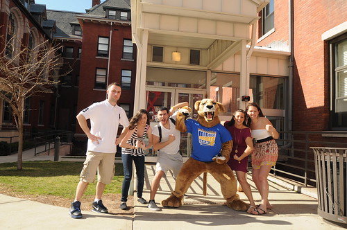 Wildcat Willie poses with a group of student outside the residential halls