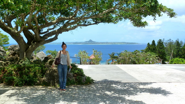 MY DAUGHTER IN THE SHADE at EXPO PARK -- The Island of IE JIMA in the Distance