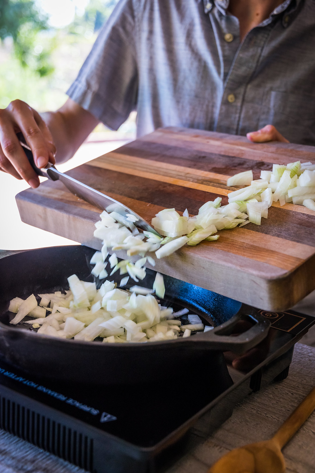 adding onions to the hot pan