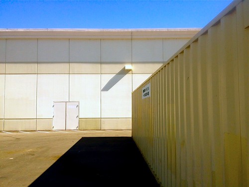 street door blue shadow sky urban building rooftop yellow retail architecture square landscape grid store big beige view box geometry empty parking cement stripe tan shapes entrance lot pale boring container shade block exit minimalism stockton slab earthtone blocky