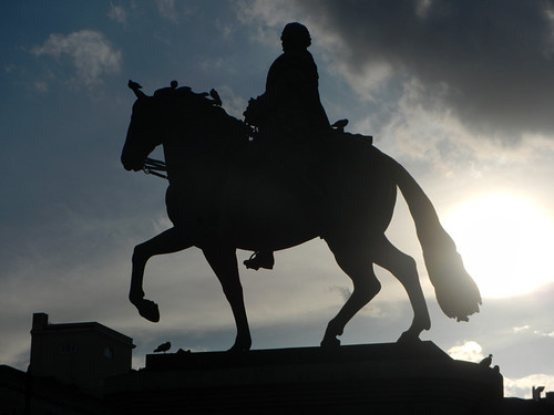 The sun flare creates a silhouette of this statue of a horse in Madrid, Spain