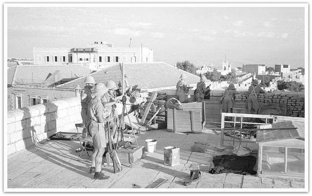British troops ( possibly Black Watch ) operating from Nordia Hotel building overlooking Jaffa Road and Barclays Bank, showing heliograph operator signaling to troops on Tower of David in the distance, Jerusalem, Palestine - circa 1938