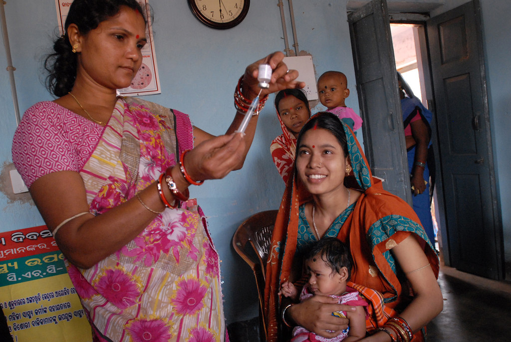 Community health worker gives a vaccination in Odisha state, India