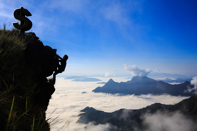 Businessman climbing a mountain, Business success concept