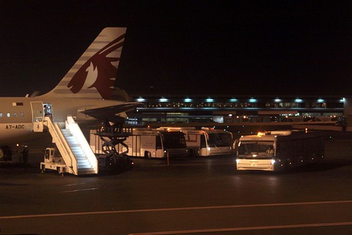 Transfer buses ready to pick up passengers from Qatar Airways A320 rego A7-ADC
