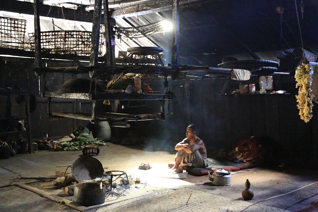 Shafts of Sunlight Filter the Smokey Interior of a Hill Tribal Wood and Iron Long House Shan State Myanmar Burma