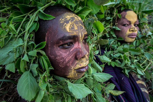 Surma tribe children with face painting and the plants in the head