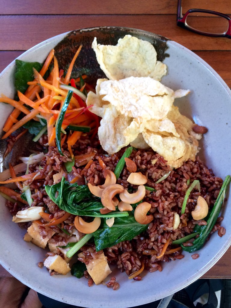Nasi goreng with brown rice, nuts, greens, carrots, crackers, etc