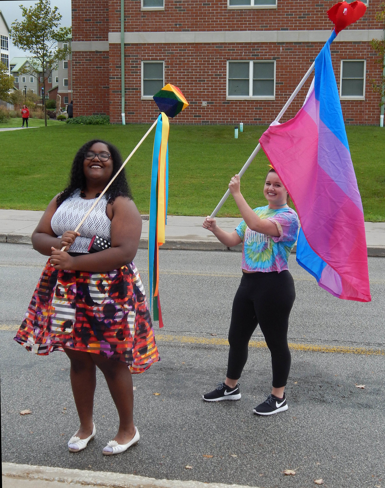 Edinboro student with Pride decorations and Bisexual Pride Flag