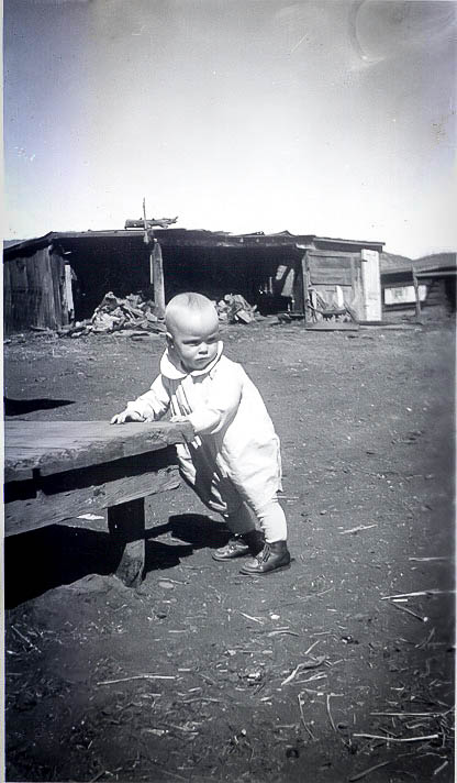 My dad as a little guy on the family homestead in Colorado. Note the boots!