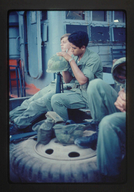 1970: u.s. soldier with helmet over muzzle of gun
