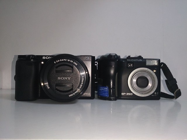 2014 Sony a6000 next to 2005 Olympus SP 350