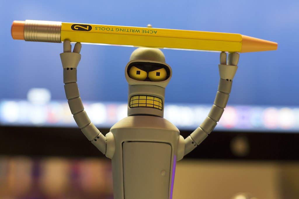 Image of robot holding onto giant pencil.