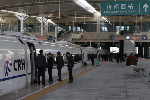 Smokers take a quick cigarette break during a short stop at Jinan West station