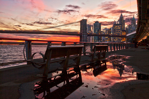 park nyc newyorkcity bridge light sunset sky urban sun color reflection skyline clouds fence buildings river twilight cityscape manhattan landmark brooklynbridge eastriver benches puddles fdrdrive