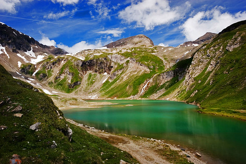 high mountain lake green water grass snow rocks blue sky clouds canon eos 20d horizontal summer landscape cornuspixels