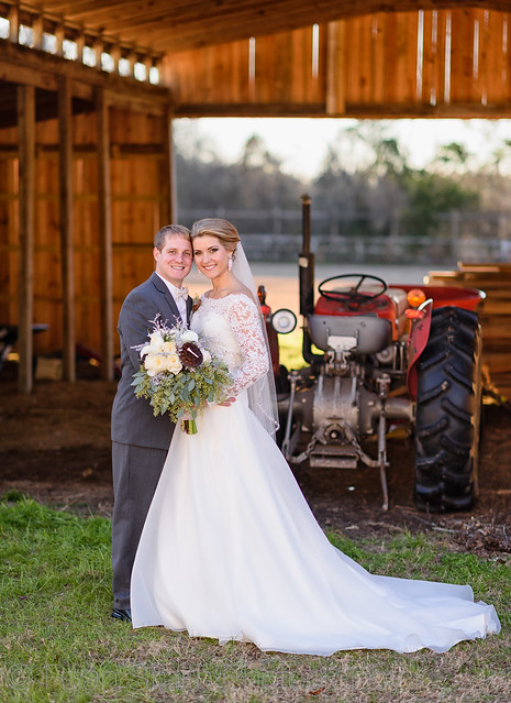 Bride and groom in front of barn - Wildberry Farms