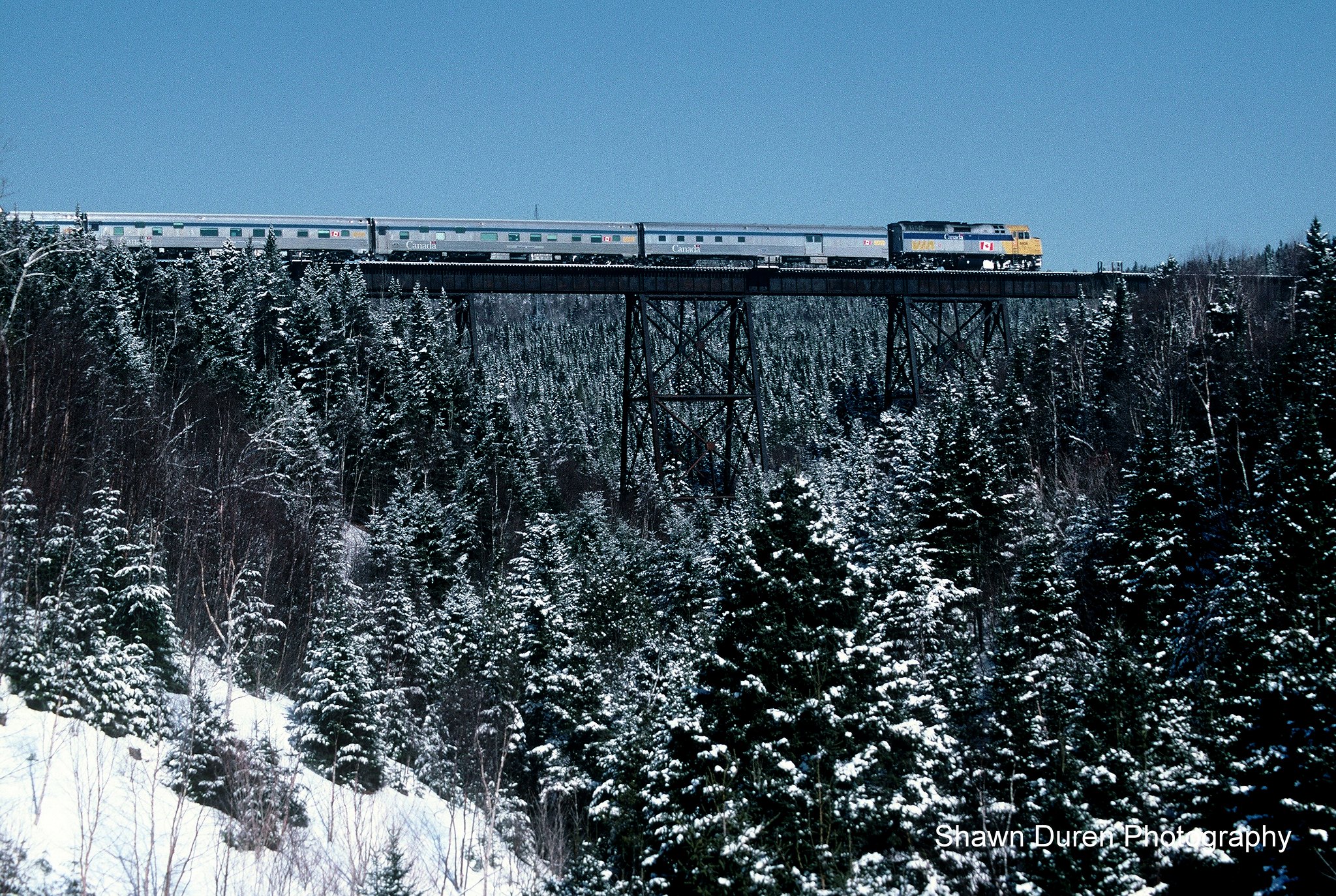 VIA Rail Train #16, the Chaleur crosses the big trestle at Gascons, Quebec, a few miles east of Port Daniel on March 22, 2004.