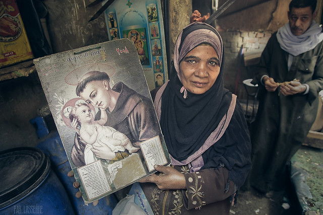 An egyptian woman, of Muslim confession, owner of a little grocery store in Cairo, shows me an icon of Saint Anthony of Padua, the patron saint of poor and sick. Cairo - Egypt - 2011