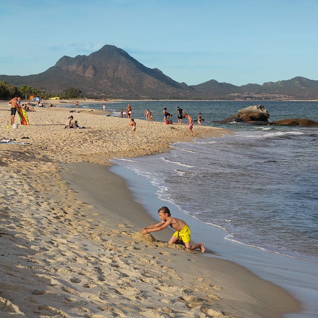 Kid on beach inspired by surroundings of Sardinia