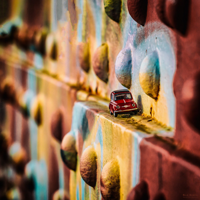 red fiat 500 on colorful old bridge