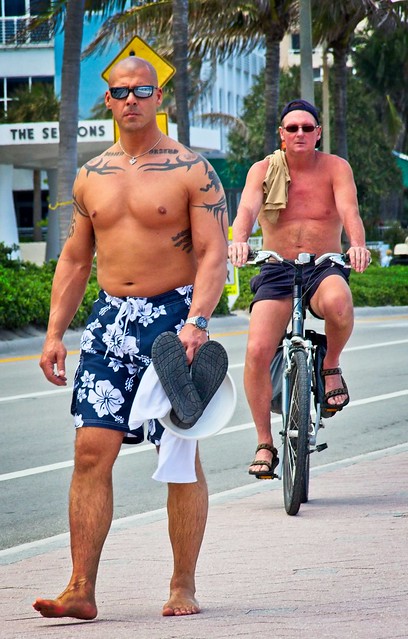 Shirtless guys walking & riding