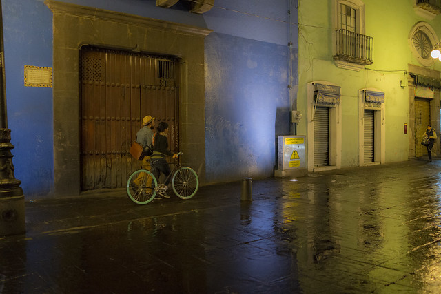 Lights reflected on puddled streets at night in Puebla, Mexico
