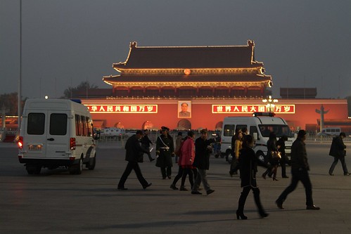 Police car chases out the last few visitors from Tiananmen Square
