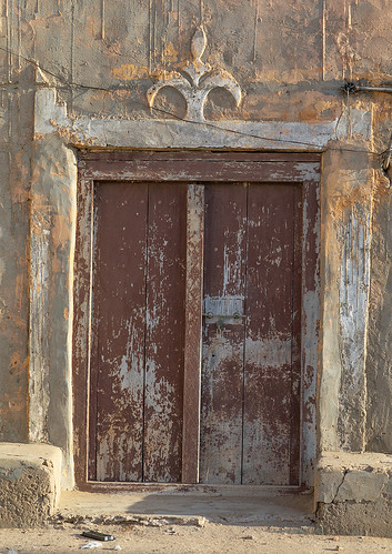 abandoned arabesque arabia arabianpeninsula arabic arabicstyle architecture buildingentrance buildingexterior builtstructure carved carvingcraftproduct colorimage cultures day dhofar door entrance exteriorview facade ghosttown gulfcountries history house housing mirbat moscha nopeople old oman oman18195 omani ornate outdoors sultanate thepast traveldestinations vertical weathered wood woodmaterial woodendoor dhofargovernorate om