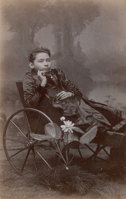 A sad girl sits in her wheelchair cdv