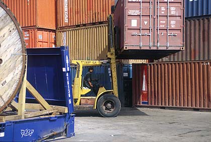 Dockers loading containers onto a cargo ship, Paraguay, by ILO, on Flickr