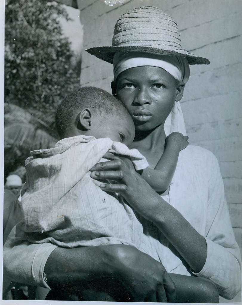 A haitian woman clutches her baby on way  to doctor