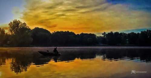lake boat fisherman sunset sky reflection