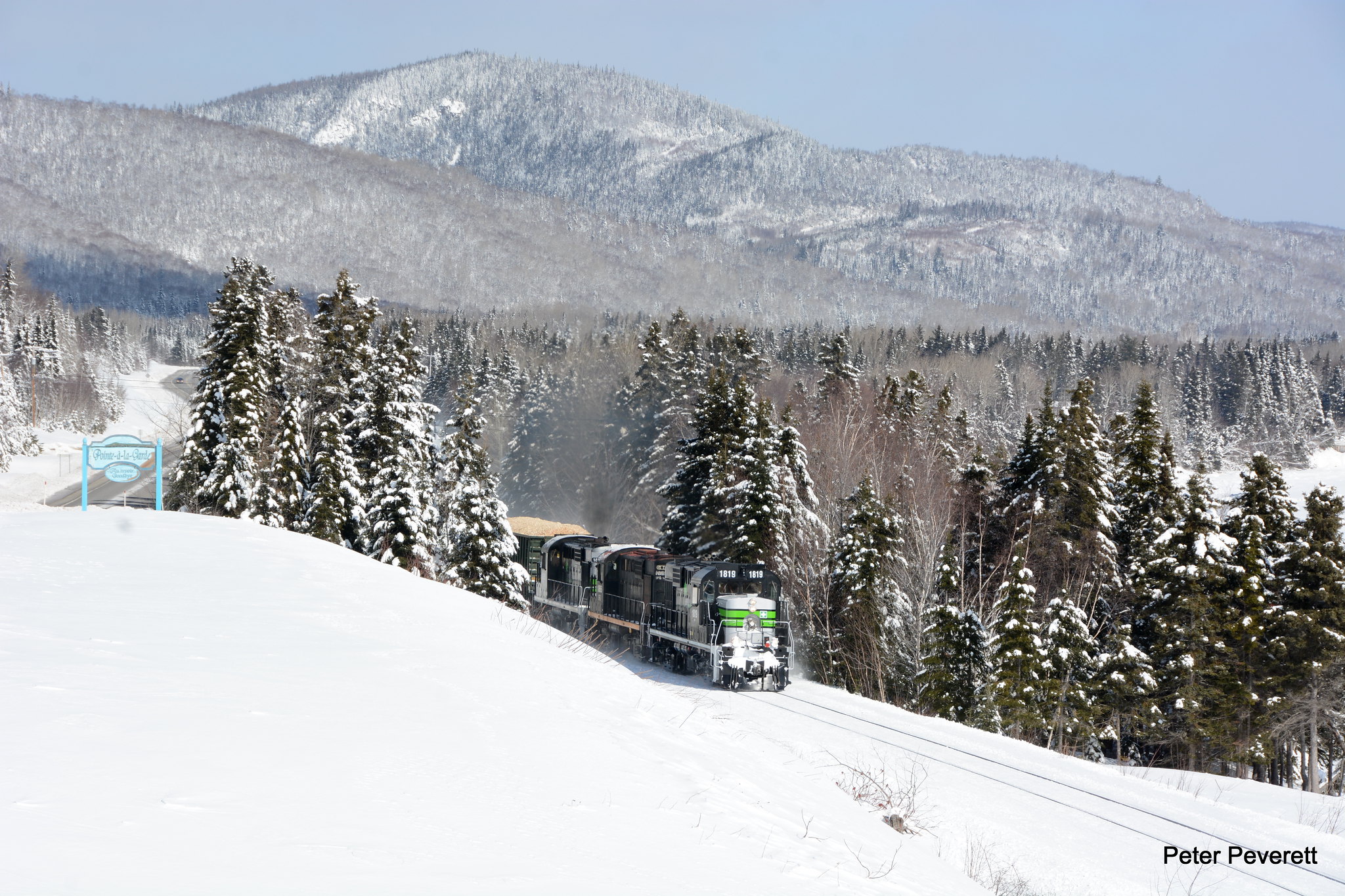 Societe du Chemin De Fer De La Gaspésie RS-18 # 1819, 1865, 1856 are westbound at Pointe-a-la -Garde, Quebec  March 4, 2017