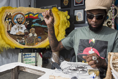 Big Chief Demond Melancon of Young Seminole Hunters works on a new Charles Neville beadwork portrait at Jazz Fest day 6 on May 5, 2018. Photo by Ryan Hodgson-Rigsbee RHRphoto.com