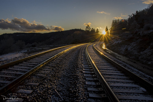 snow sunset dusk cold winter rail rails railroad sun light reflection