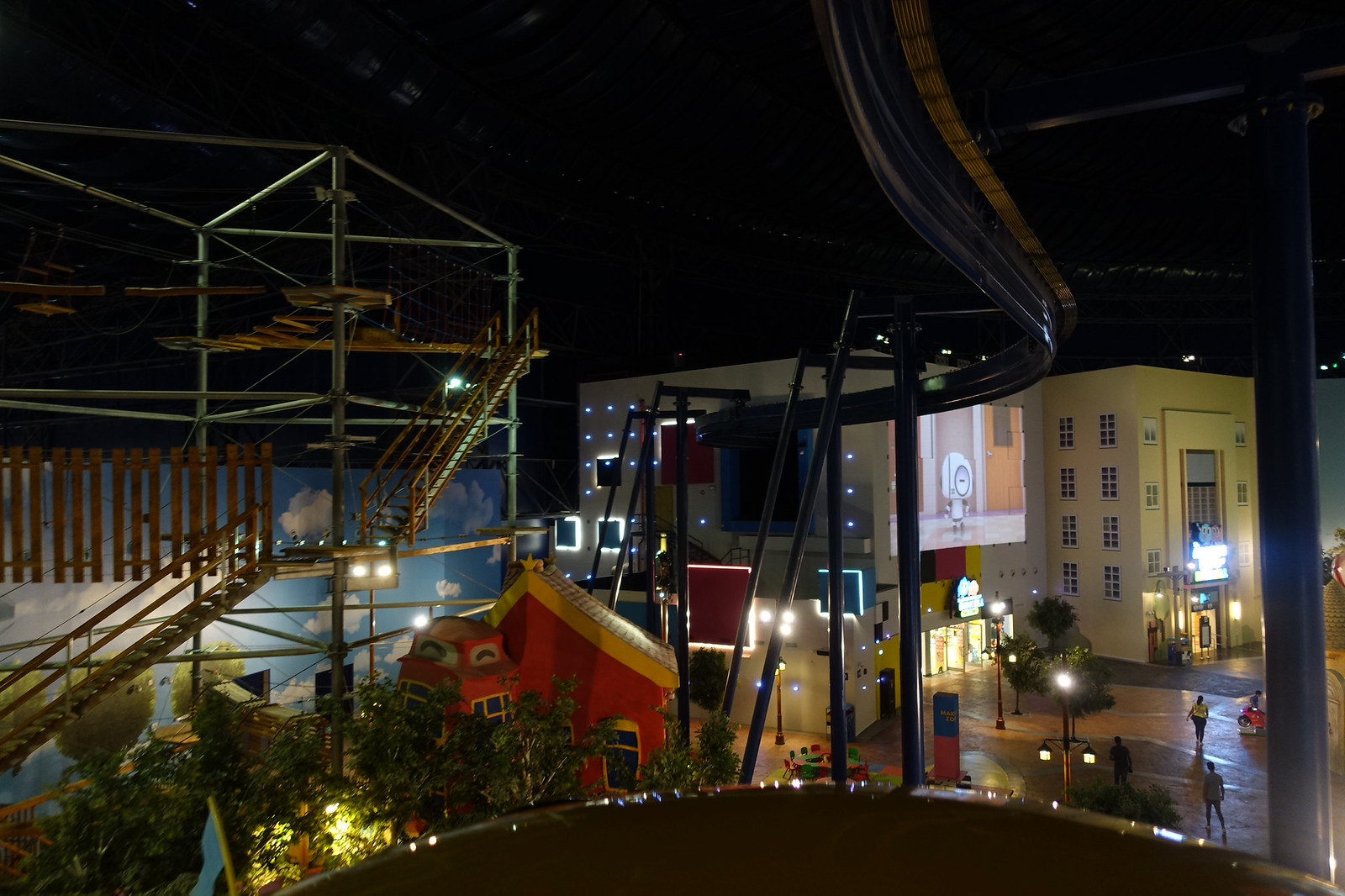 Looking down on the Cartoon Network zone's colourful houses, ropes course and lit streets