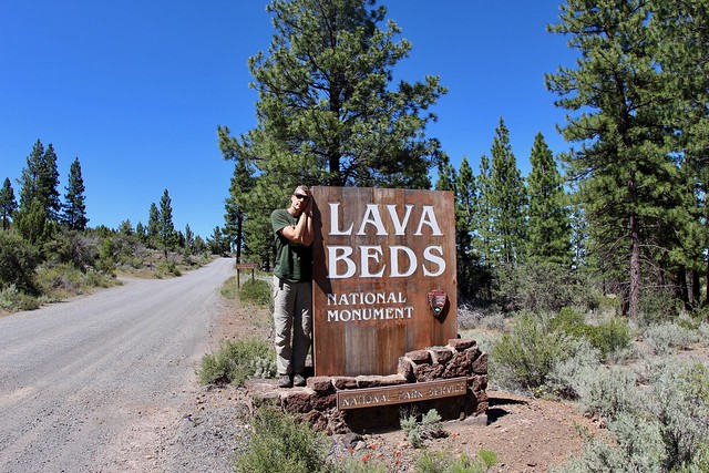David sleeping by the side of Lava Beds sign