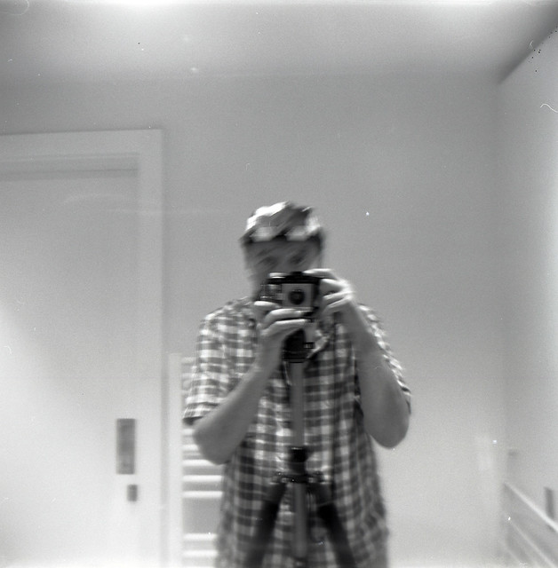 reflected self-portrait with Kodak Brownie Cresta II camera and cap