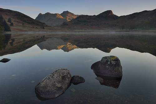 bleatarn langdales tarn first light bankholiday mist rocks stones boulders shore shoreline lake cumbria lakedistrict lakeland view scenic thelakes lakedistrictnationalpark nationaltrust fell fells cumbrian mountains landscape imagestwiston district national park countryside mountain super still water reflection reflections morning mirror blue cloudless englishlakedistrict lakes thelakedistrict reflected waterreflections sunrise dawn calm serene stupidoclock wideangle wide angle sidepike lingmoorfell pikeoblisco pikes greatlangdale littlelangdale graduated unesco worldheritagesite